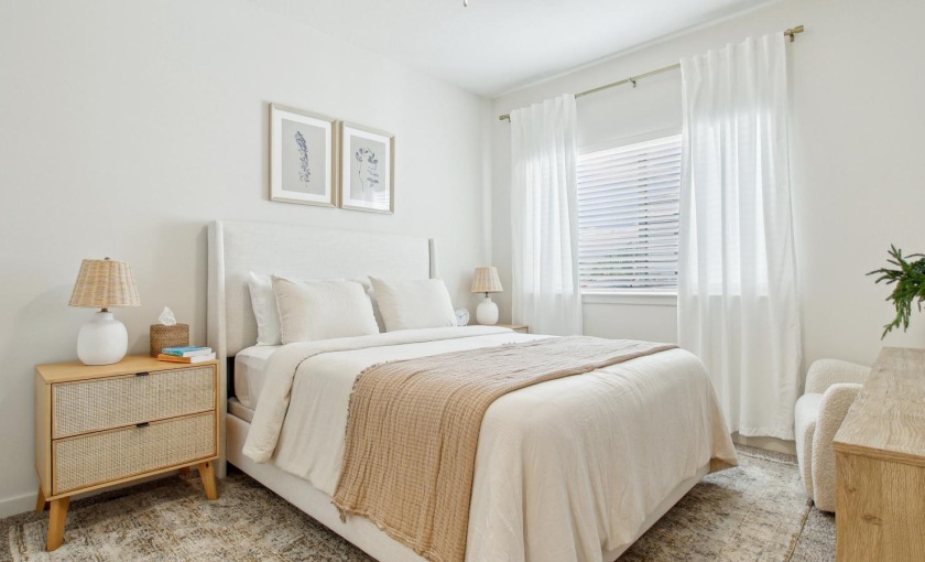 a bedroom with a bed and a table